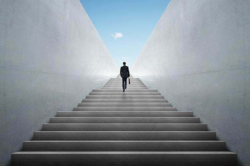 Businessman climbing stairs