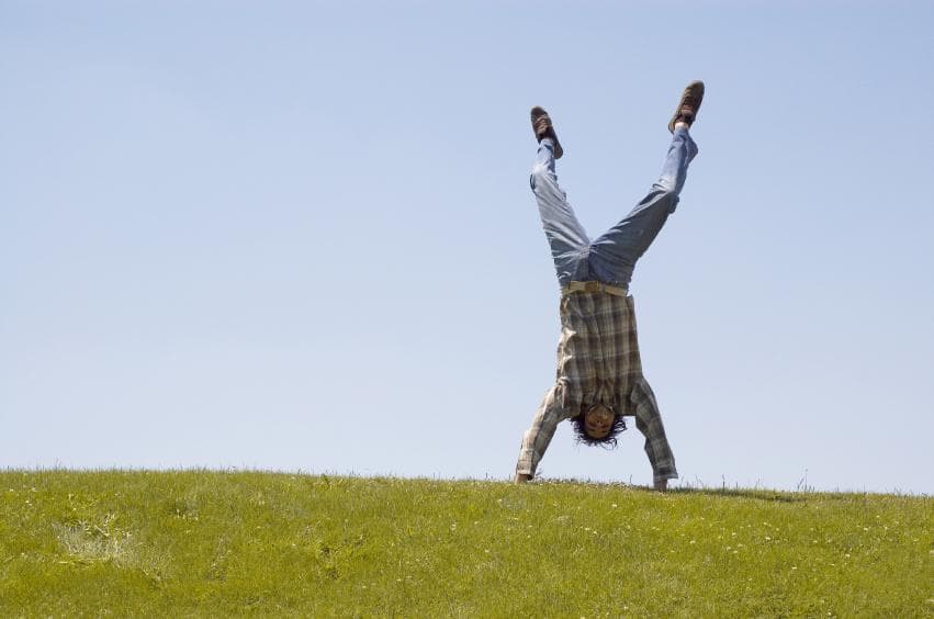 Student handstand on grass